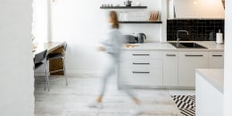 Kitchen with blurred human figure