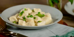 Homemade ricotta gnocchi gets smothered in a lemony butter sauce with mint and spring peas.