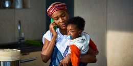 Woman with baby son in kitchen