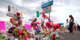 People leave flowers at a makeshift memorial for shooting victims at the Cielo Vista Mall Walmart, in El Paso, Texas