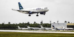 A JetBlue airplane lands at Fort Lauderdale-Hollywood International Airport (FLL) in Fort Lauderdale, Fla., on May 21, 2022.