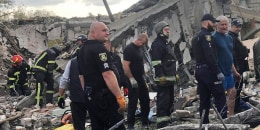 Emergency workers search for victims of the deadly Russian rocket attack that killed more than 40 people in the village of Hroza near Kharkiv, Ukraine.