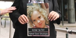 Shira Havron holds photo of her 3-year-old niece Yahel Gani Shoham in front of EU parliament holding