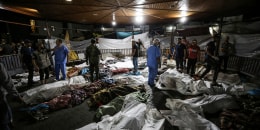 The bodies of the dead, killed by an explosion at the al-Ahli hospital, are gathered in the front yard of the al-Shifa hospital in Gaza City.