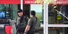 Law enforcement officers near an emergency department entrance at Central Maine Medical Center during an active shooter situation, in Lewiston