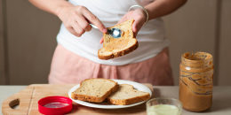 Woman making peanut butter sandwich