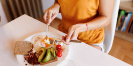 Close-up shot of unrecognizable young woman having healthy breakfast at home