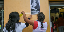 Relatives of missing teenager Pamela Cocina Rosales, 14, stick a missing person poster on a wall as part of her search, in Xochimilco.