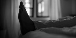 Man's feet in bed