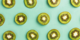 The patterns of the slices of kiwi fruit on green background.