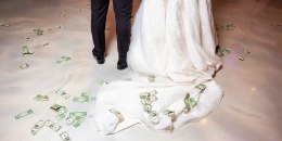 Bride and groom first dance with money on floor