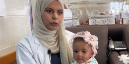 Baby Malak with his adoptive mother Amal Khatleh, 32, at the Emirati hospital in Rafah, southern Gaza. 