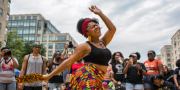 A woman dances to live music as she celebrates Juneteenth at