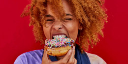 Portrait of woman eating a donut