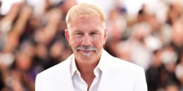  Kevin Costner wearing a white suit attends the "Horizon: An American Saga" Photocall at the 77th annual Cannes Film Festival
