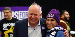  Minnesota Gov. Tim Walz speaks with union organizers before they march on businesses in downtown Minneapolis on Oct. 14, 2022.