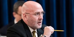 Clay Higgins speaks, holds a pencil in hand