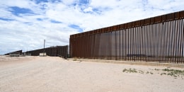The U.S. - Mexico border wall in an empty landscape