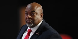 Mark Robinson speaks on stage on the first day of the Republican National Convention at the Fiserv Forum in Milwaukee