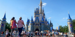 People walk in front of Cinderella's Castle.