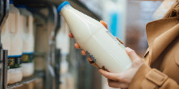 Close up shot of woman holding a bottle of milk