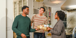 three people exchanging gifts with their brother in law