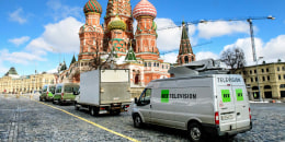 RT vans parked in front of St. Basil's Cathedral and the Kremlin next to Red Square