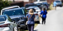 Parents walk to Apalachee High School after a shooting at the school Wednesday, Sept. 4, 2024, in Winder, Ga. 