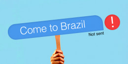 Photo illustration of hand holding a sign that reads "Come to Brazil" with a "Not sent" error message next to it 