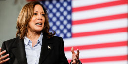Kamala Harris speaks in front of an American flag background