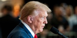 Donald Trump speaks into a microphone