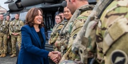Kamala Harris shakes hands with soldiers near a plane