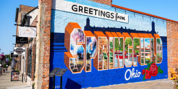 A mural that says, “Greetings from Springfield Ohio” in downtown Springfield.