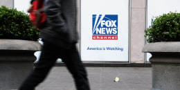 A pedestrian outside News Corporation headquarters