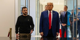 Volodymyr Zelenskyy speaks with Donald Trump next to him at a meeting