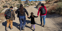 Colombian asylum-seekers walk through the desert after crossing the U.S.-Mexico border on Sept. 22, 2024 near Jacumba Hot Springs, Calif.