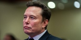 Elon Musk listens as President-elect Donald Trump speaks