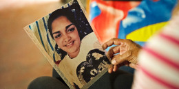 Aurimar Iturriago Villegas's mother looks at her photo at her home in Venezuela.