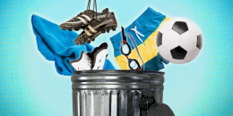 Cropped image of the top half of a trash can, against a blue background. Several objects are being tossed into the can, including a beach towel, shin guards, soccer cleats, swim goggles, swim trunks, and a soccer ball.