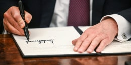 Image: President Donald Trump signs executive orders in the Oval Office