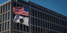 A U.S. flag and an Education Department flag fly.