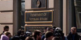 Members of the media cover a rally outside the Department of Veterans Affairs headquarters in Washington on Feb. 13, 2025.