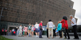 People wait in line to enter the Smithsonian National Museum of African American History and Culture on the National Mall in in 2017.