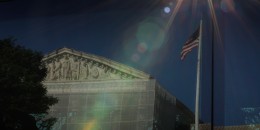 The U.S. Supreme Court, reflected against a bus window on Capitol Hill 