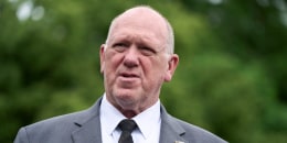 Tom Homan speaks while standing outside