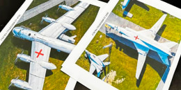 Two photos of planes are laid on a table