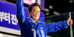 Lee Jae-Myung holds up two thumbs up