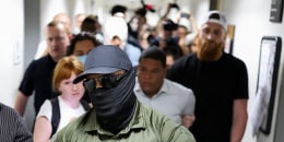 An ICE agent in a mask leads the way as a man is detained after his immigration court hearing in New York on June 6, 2025. 