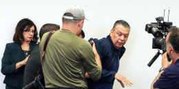 Sen.  Alex Padilla, D-Calif., is removed from the room during a news conference with Department of Homeland Security Secretary Kristi Noem in Los Angeles on June 12, 2025.