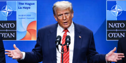 Donald Trump speaks on stage at a podium